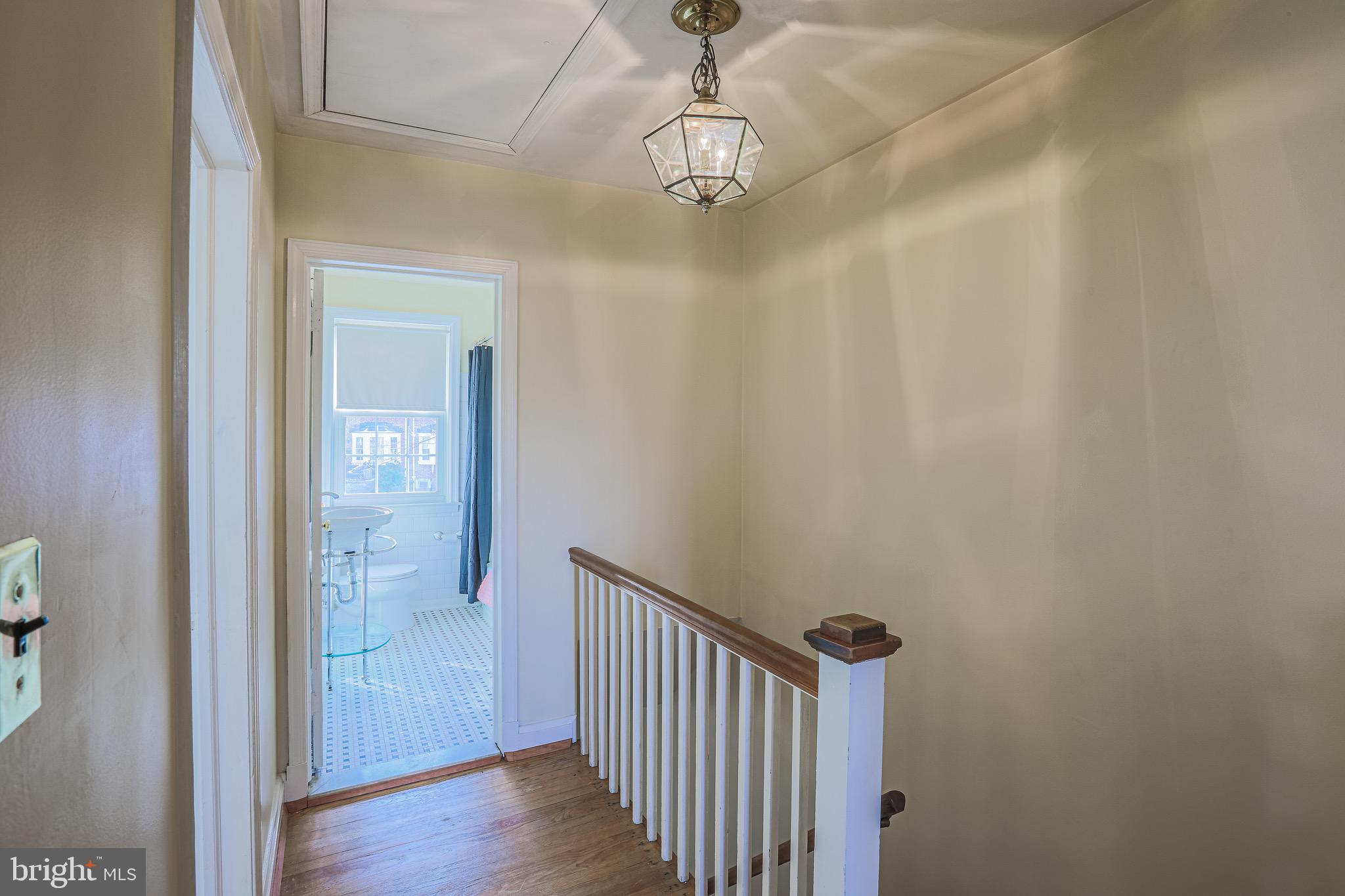 200 Stanmore Road Baltimore, MD 21212 - Photo 14 of 27 a view of a hallway with wooden floor and staircase