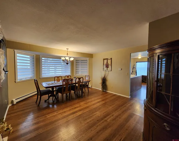 a dining room with furniture and wooden floor