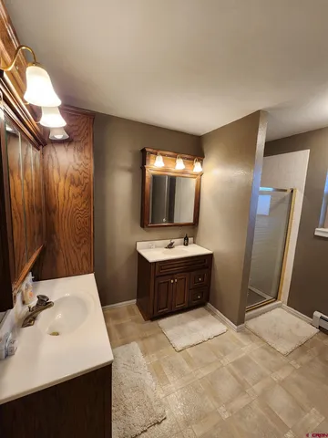 a large bathroom with a sink and a mirror