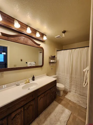 a bathroom with double vanity sink and a mirror
