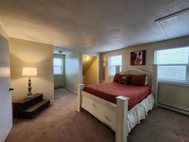 a spacious bedroom with a bed and a couch