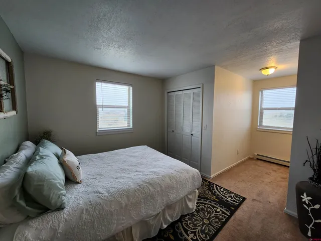 an empty room with wooden floor and window