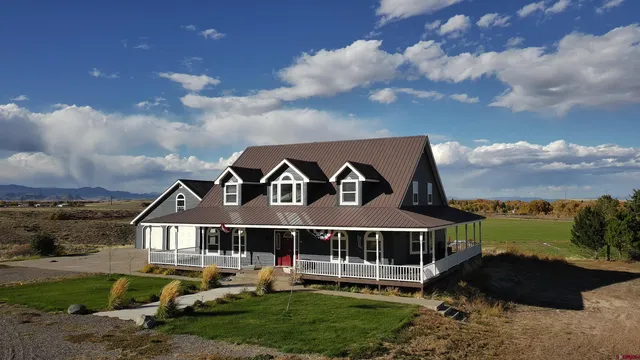 a view of a large house with a big yard and plants