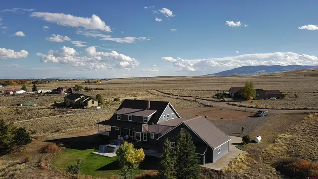an aerial view of a house with a ocean view