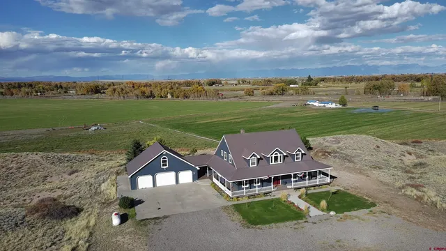 an aerial view of a house with big yard