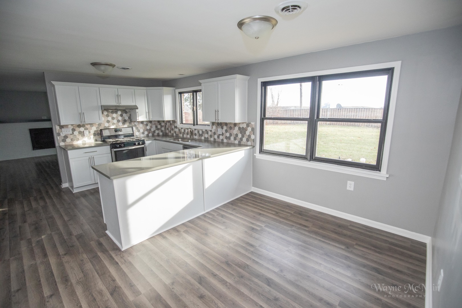408 Hillside Road Joliet, IL 60433 - Photo 5 of 14 a view of a kitchen counter space with wooden floor and electronic appliances