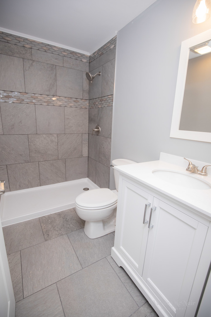 408 Hillside Road Joliet, IL 60433 - Photo 8 of 14 a bathroom with a sink a toilet and shower