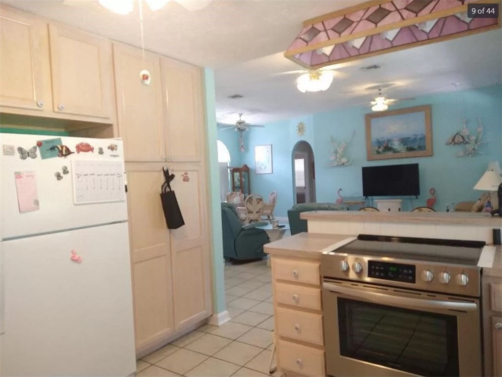 401 Coply Terrace Sebastian, FL 32958 - Photo 11 of 36 a kitchen with a stove a refrigerator and cabinets
