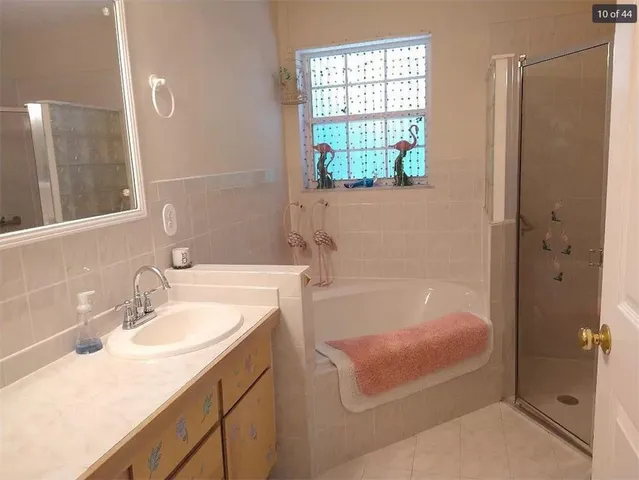 a bathroom with a tub sink and mirror