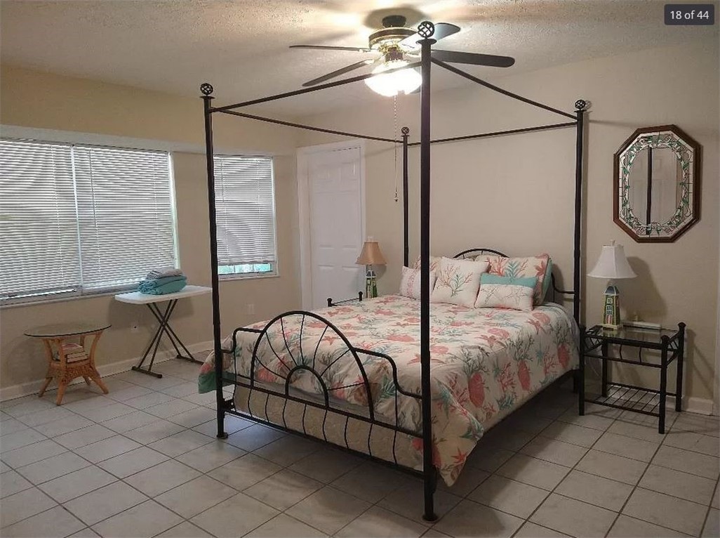401 Coply Terrace Sebastian, FL 32958 - Photo 16 of 36 a bedroom with a bed a desk and chair