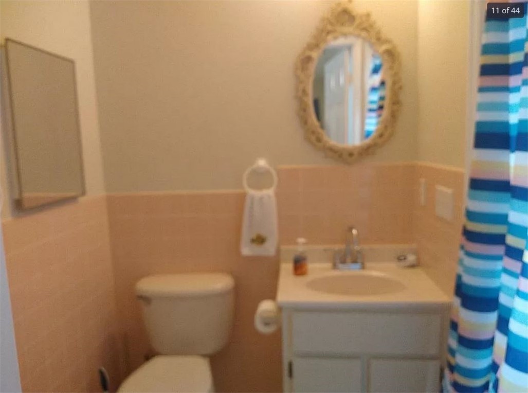 401 Coply Terrace Sebastian, FL 32958 - Photo 17 of 36 a bathroom with a toilet sink and mirror