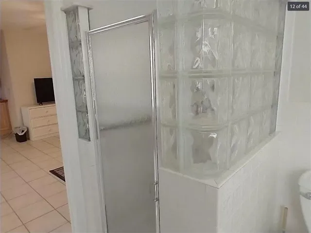 a bathroom with a glass shower door