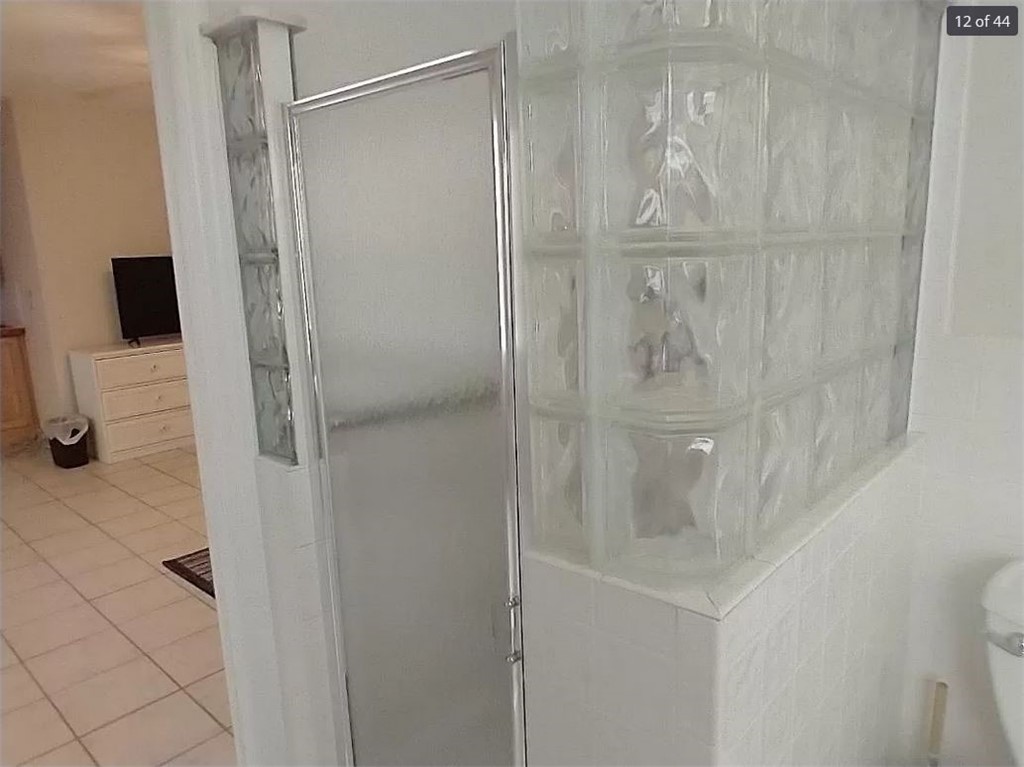 401 Coply Terrace Sebastian, FL 32958 - Photo 20 of 36 a bathroom with a glass shower door