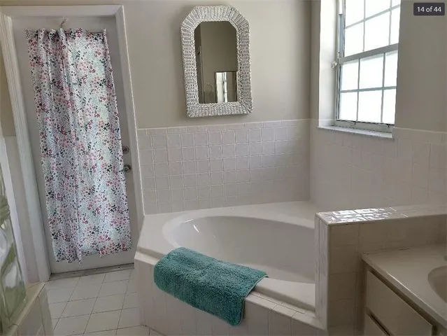a bathroom with a bathtub and shower