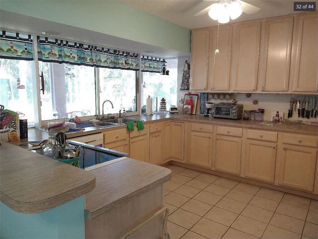 401 Coply Terrace Sebastian, FL 32958 - Photo 9 of 36 a kitchen with a sink stove and cabinets