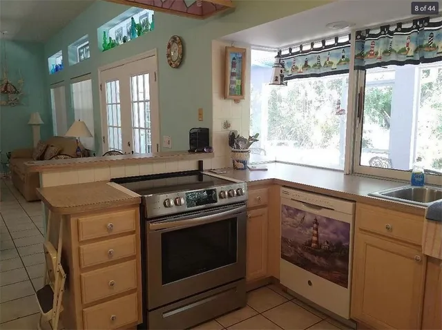 a stove top oven sitting inside of a kitchen