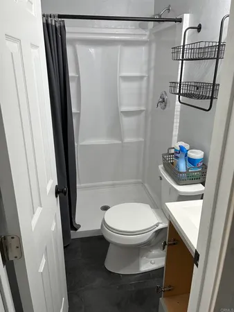 a bathroom with a toilet and a shower