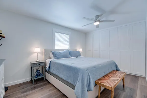 a bedroom with a bed and wooden floor