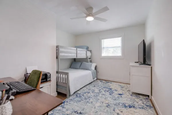 a bedroom with a bed and a television