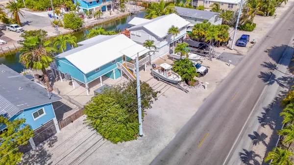 an aerial view of a house with a yard and garden