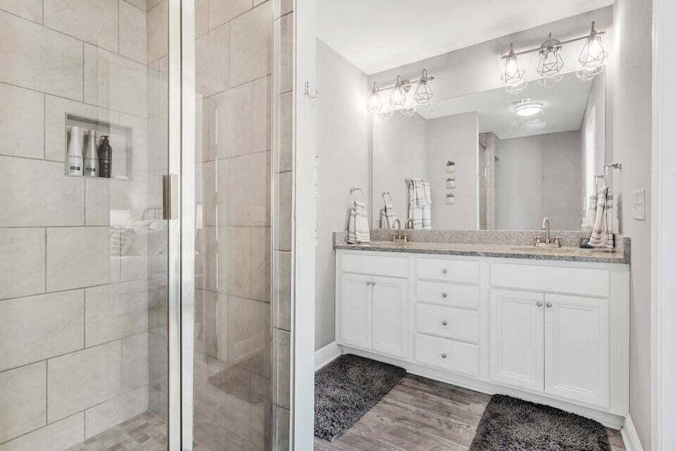 89 Crossing Lane, Unit F Santa Rosa Beach, FL 32459 - Photo 15 of 30 a bathroom with a granite countertop double vanity and a mirror