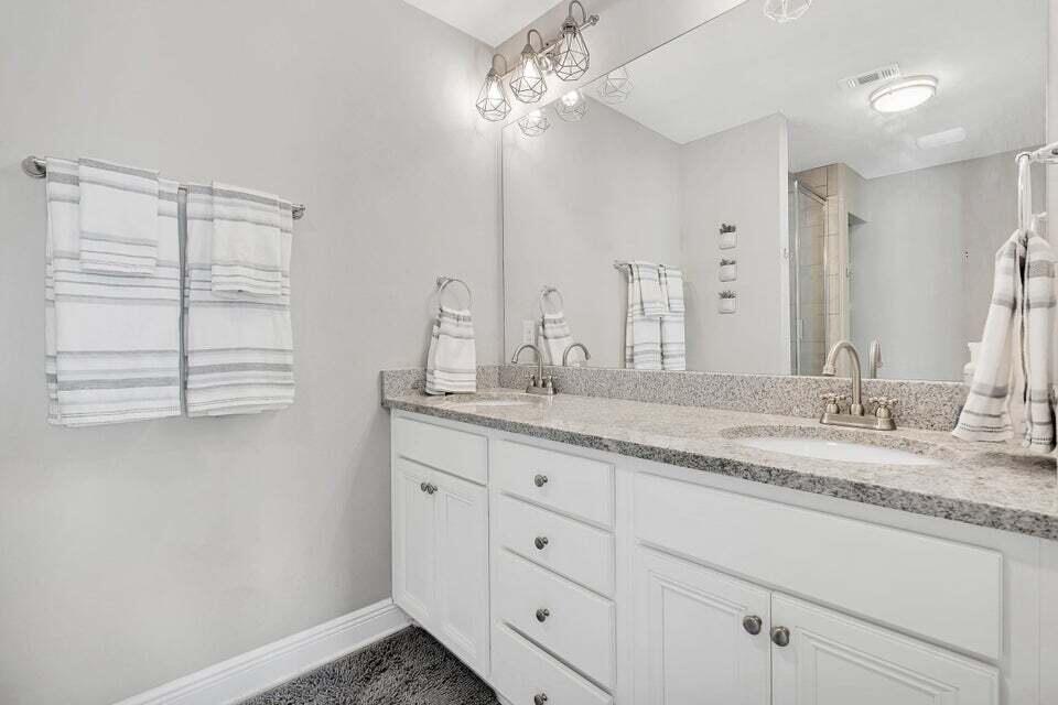 89 Crossing Lane, Unit F Santa Rosa Beach, FL 32459 - Photo 16 of 30 a bathroom with a granite countertop sink and a mirror