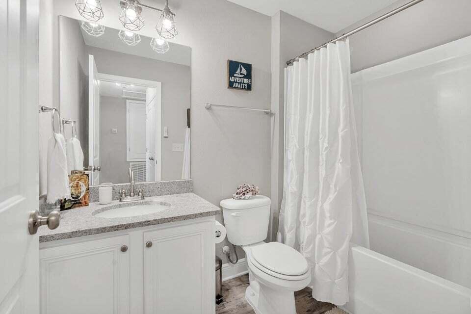 89 Crossing Lane, Unit F Santa Rosa Beach, FL 32459 - Photo 20 of 30 a bathroom with a granite countertop sink toilet and shower