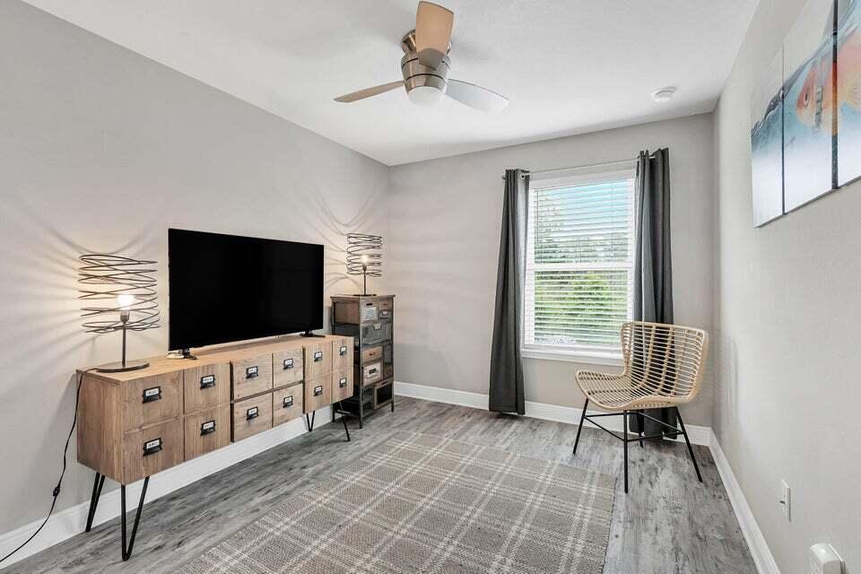 89 Crossing Lane, Unit F Santa Rosa Beach, FL 32459 - Photo 21 of 30 a living room with furniture and a flat screen tv