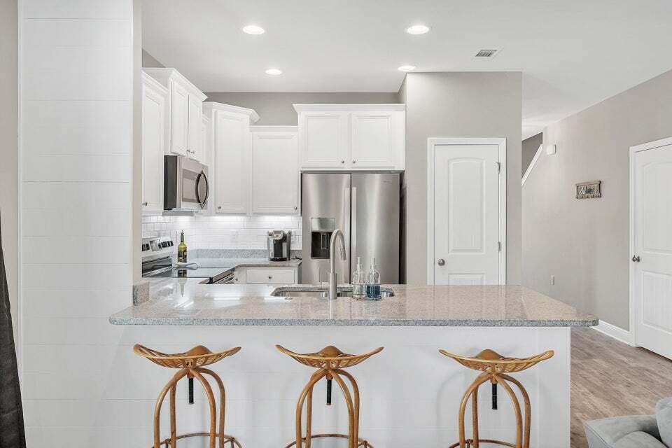 89 Crossing Lane, Unit F Santa Rosa Beach, FL 32459 - Photo 6 of 30 a kitchen with stainless steel appliances granite countertop a sink and a refrigerator