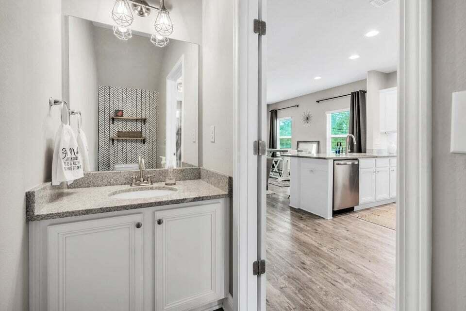 89 Crossing Lane, Unit F Santa Rosa Beach, FL 32459 - Photo 10 of 30 a bathroom with a granite countertop sink a mirror and vanity