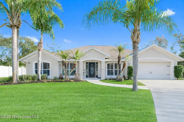 a front view of house with yard and green space