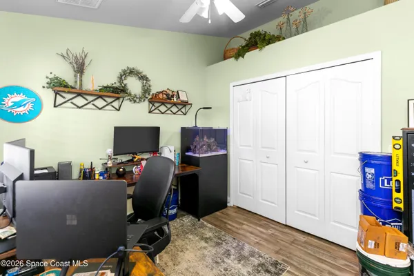 a view of a workspace with furniture and a window