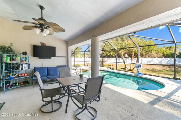 a dining room with livingroom view and a floor to ceiling window