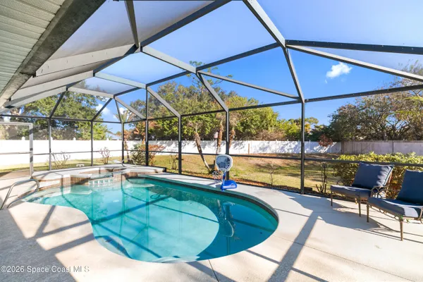 a view of a swimming pool with a patio