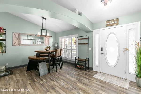 a view of a workspace with furniture window and wooden floor