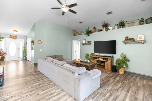 a living room with furniture and a flat screen tv
