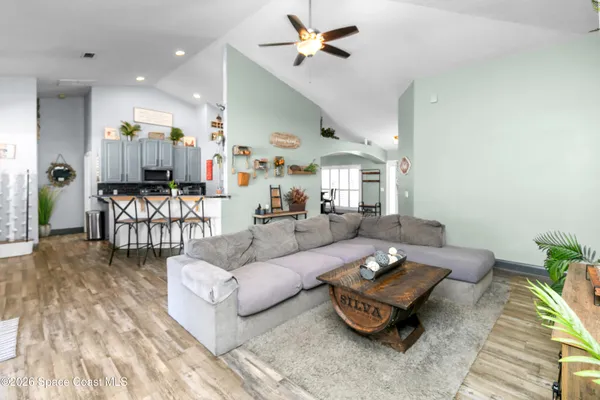 a living room with furniture and wooden floor