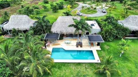 an aerial view of a house with swimming pool garden and patio