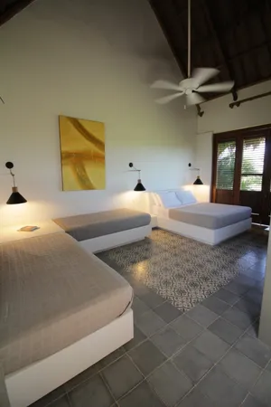 a bedroom with a bed and painting on the wall