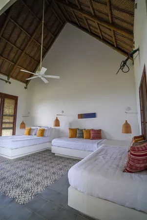 a bedroom with two beds and painted walls