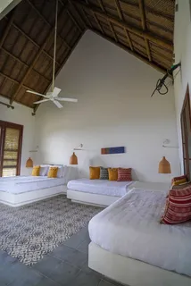 a bedroom with two beds and painted walls