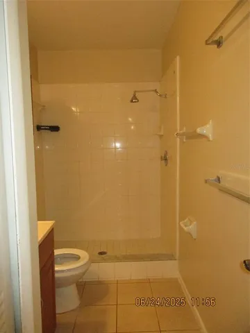 a bathroom with a toilet and shower