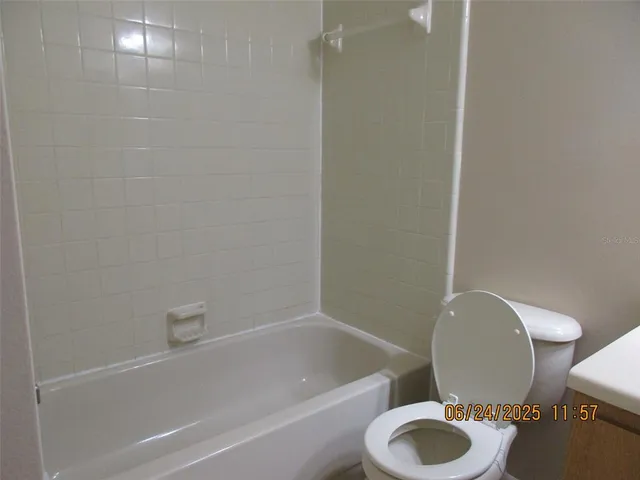 a bathroom with a toilet and a bathtub