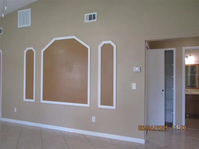 a view of an empty room with windows