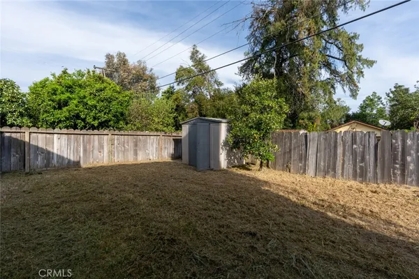a view of a house with a yard and sitting area