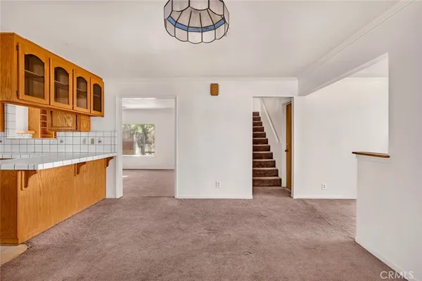 a view of kitchen with furniture and staircase