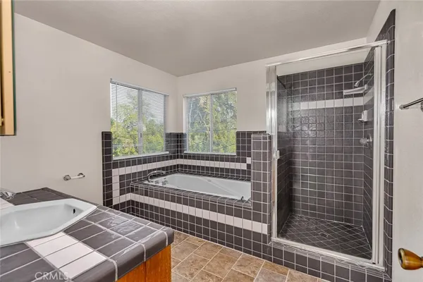a bathroom with a bathtub and next to a window