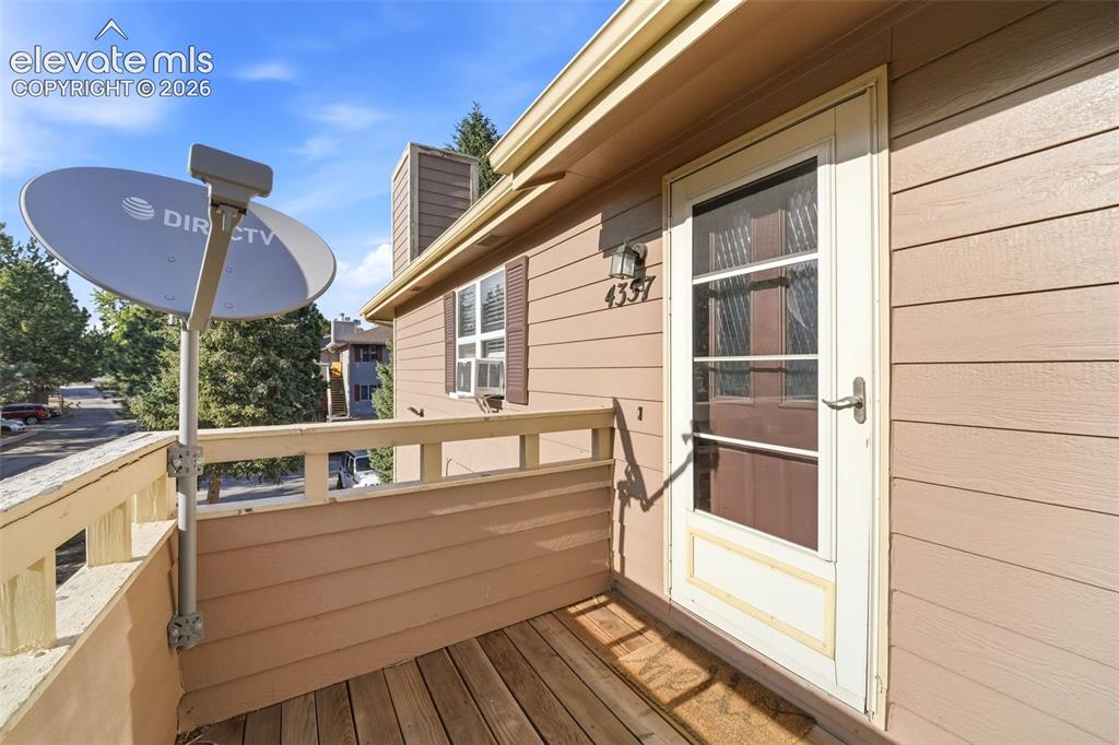 4357 Hunting Meadows Circle Colorado Springs, CO 80916 - Photo 2 of 20 a view of a balcony with two chairs and a barbeque
