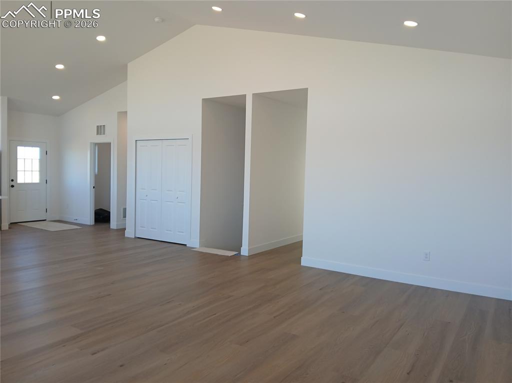 19981 Cloudfield Point Colorado Springs, CO 80928 - Photo 14 of 42 an empty room with wooden floor and windows
