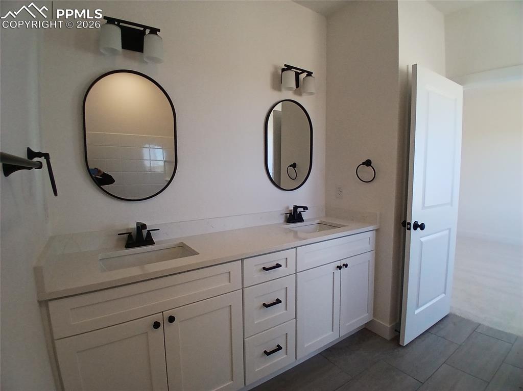 19981 Cloudfield Point Colorado Springs, CO 80928 - Photo 17 of 42 a bathroom with a sink and a mirror